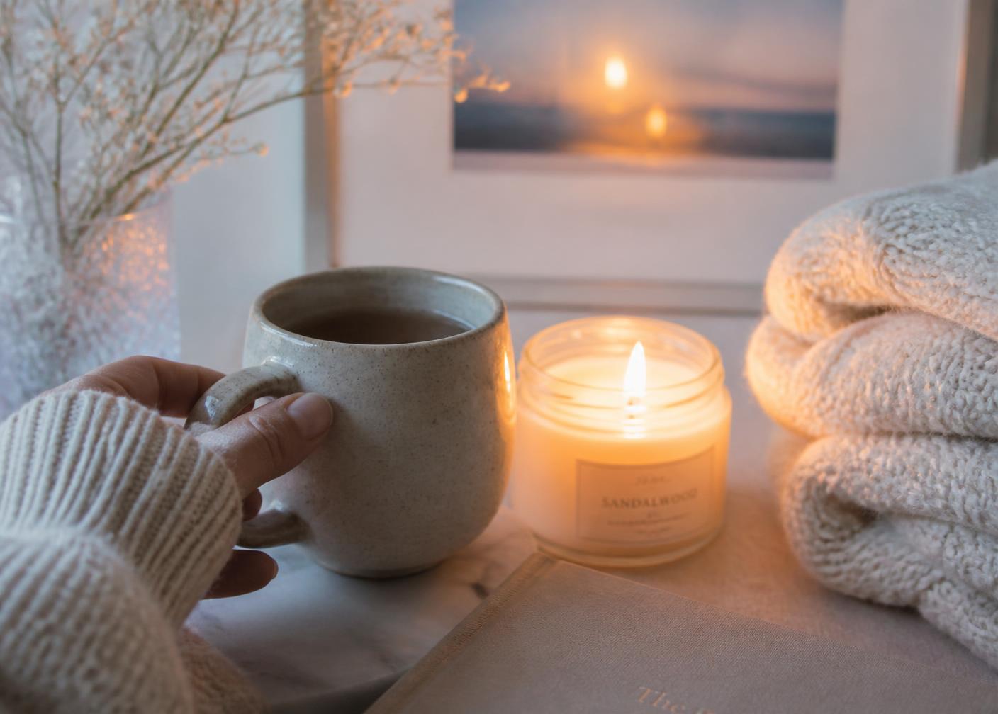 A calm evening self-care moment with a warm drink and candlelight